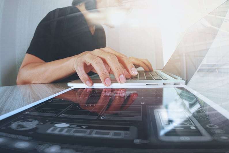 Website designer working digital tablet and computer laptop with smart phone and digital design diagram on wooden desk as concept